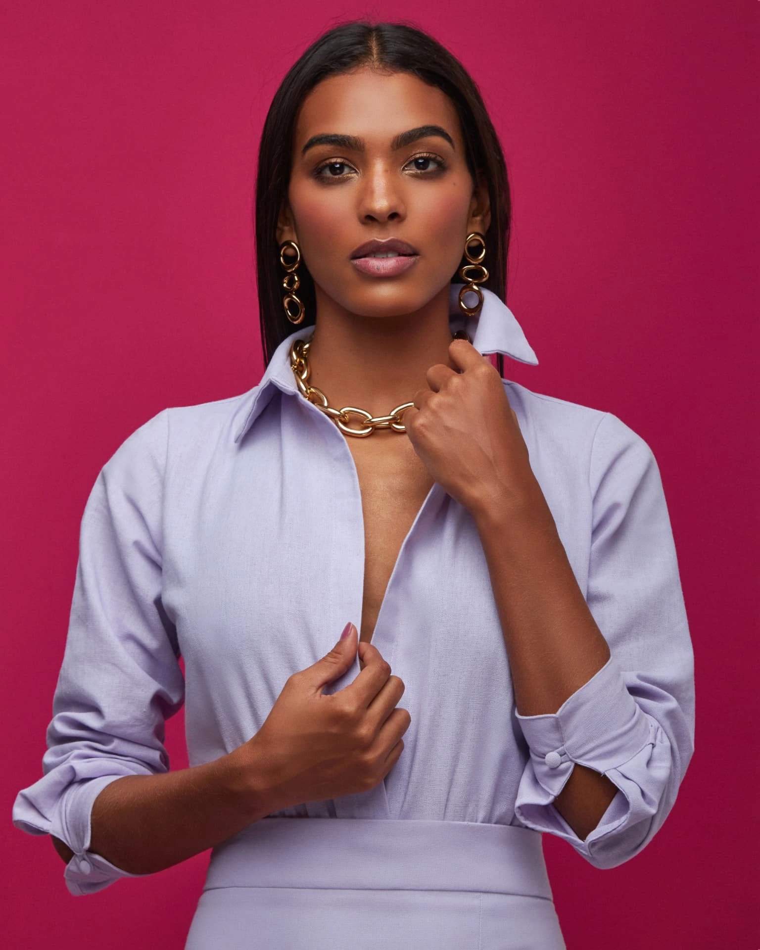 Beauty portrait of Anaiza Ferreira in a lilac shirt against a magenta background